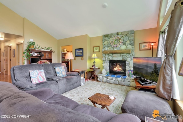 living room with lofted ceiling and a fireplace