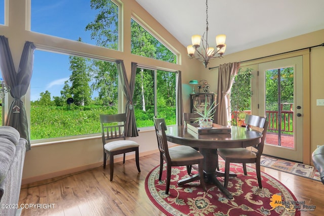 dining space featuring hardwood / wood-style floors, a wealth of natural light, and a notable chandelier