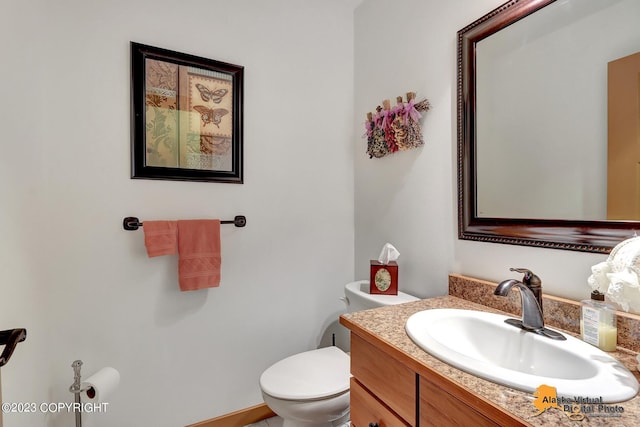 bathroom with toilet and vanity