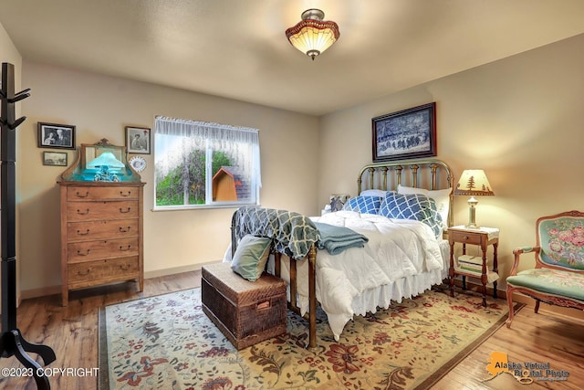 bedroom with hardwood / wood-style flooring