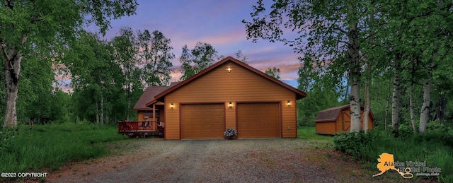 view of garage at dusk