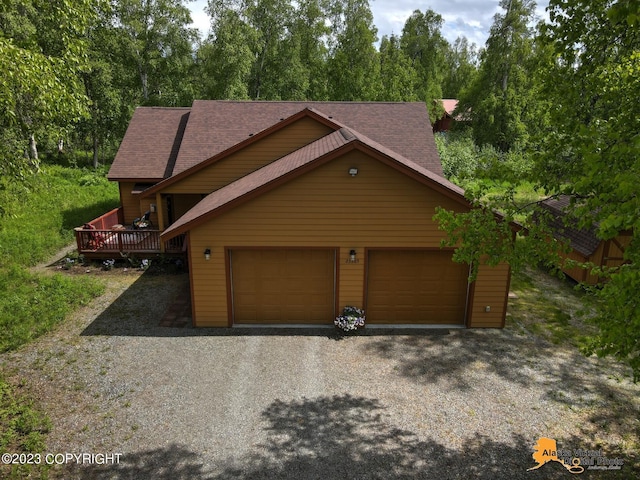 view of front of home with a deck and a garage