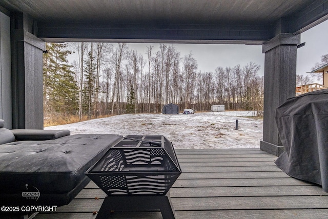 snow covered deck with grilling area