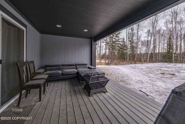 snow covered deck featuring an outdoor living space