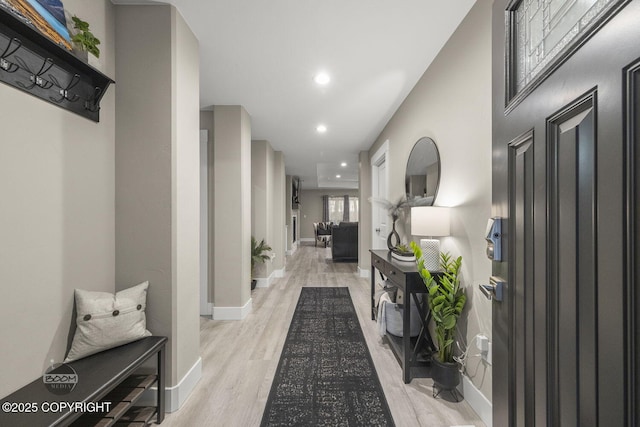 corridor with light hardwood / wood-style floors