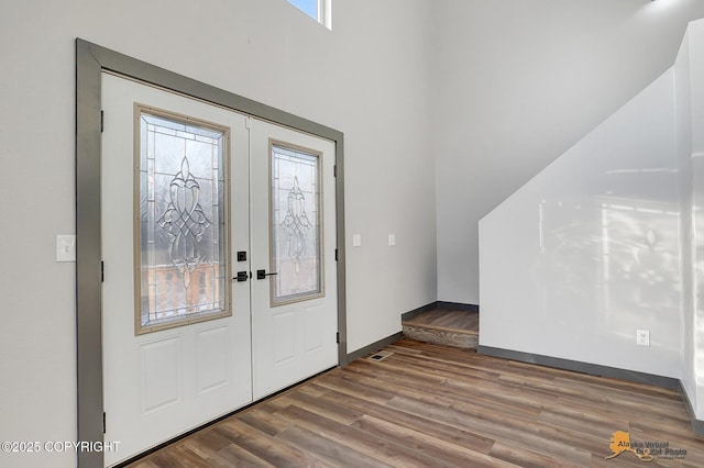 foyer entrance featuring hardwood / wood-style flooring and french doors