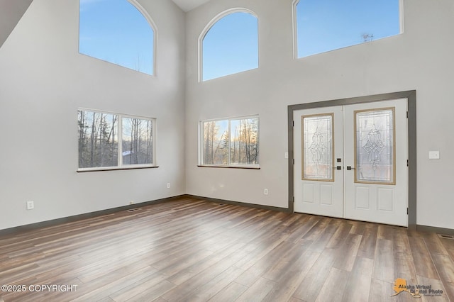 entryway with dark hardwood / wood-style flooring and french doors