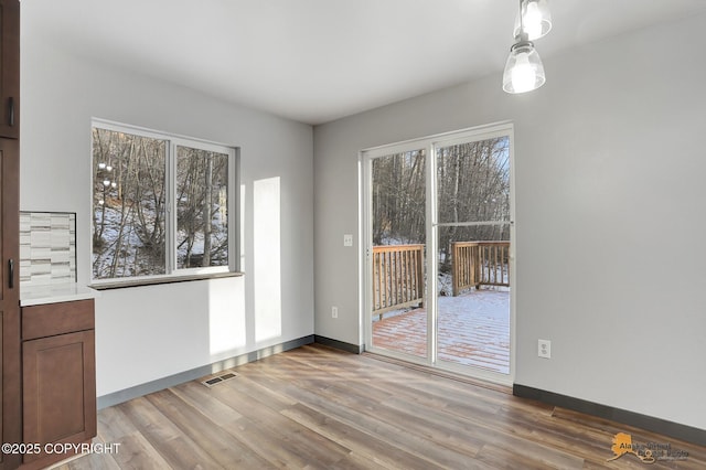 unfurnished dining area with hardwood / wood-style flooring