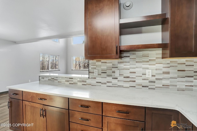 kitchen with decorative backsplash and light stone countertops