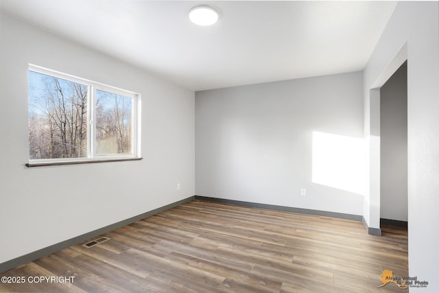 empty room with hardwood / wood-style flooring