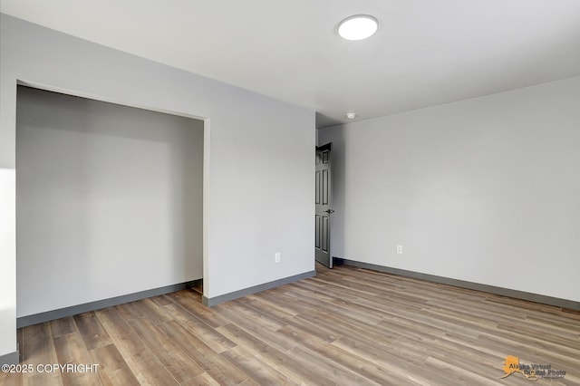 empty room with light hardwood / wood-style floors