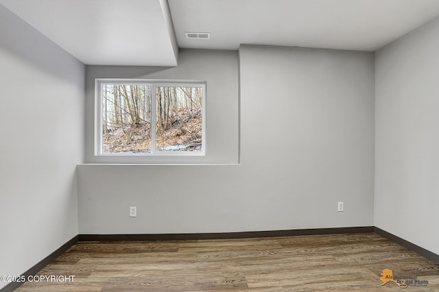 empty room with hardwood / wood-style floors