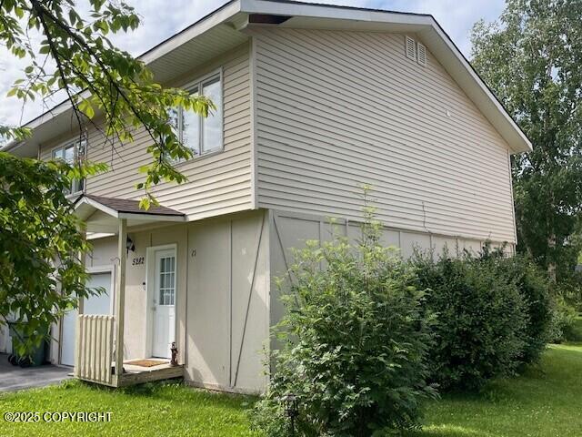 view of side of property with a lawn