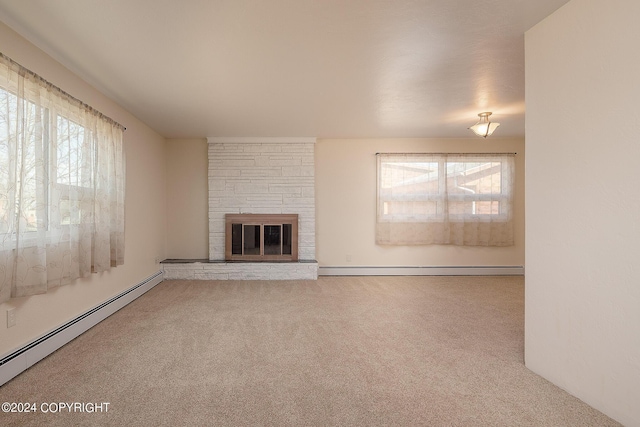 unfurnished living room with carpet floors, a fireplace, and a baseboard heating unit