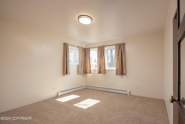 carpeted empty room with baseboard heating