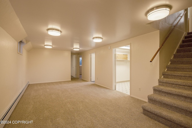 basement with carpet flooring and a baseboard heating unit