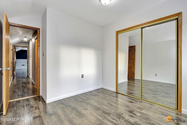 unfurnished room featuring hardwood / wood-style flooring and vaulted ceiling