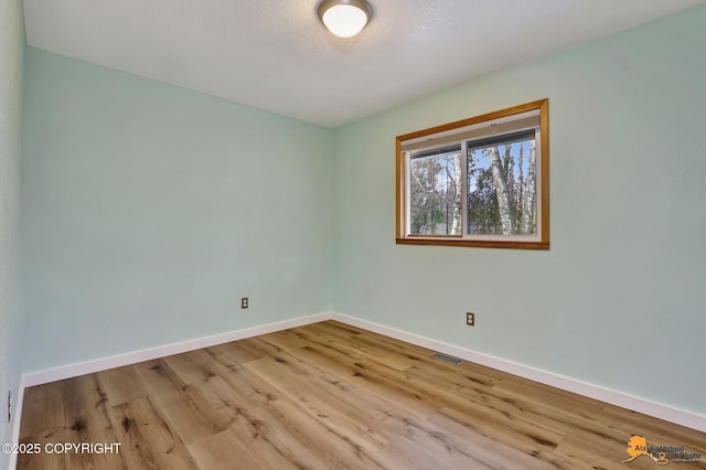 unfurnished room featuring light hardwood / wood-style floors