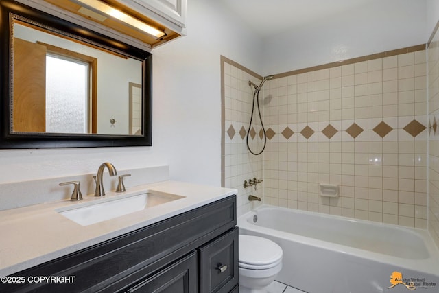 full bathroom featuring vanity, tiled shower / bath, and toilet