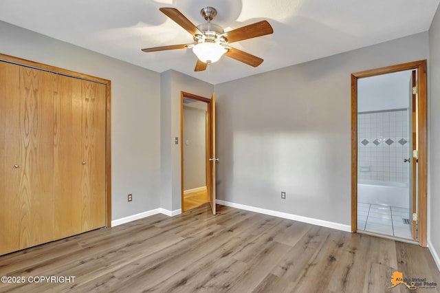 unfurnished bedroom with ceiling fan, a closet, connected bathroom, and light hardwood / wood-style flooring