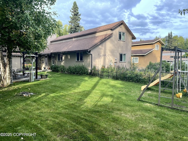 exterior space with a lawn and a playground