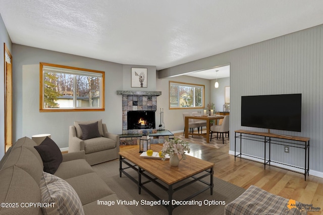 living room with a tile fireplace and wood-type flooring