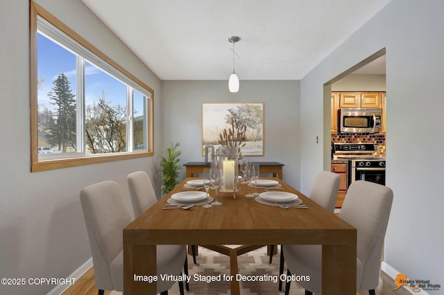 dining area featuring a textured ceiling