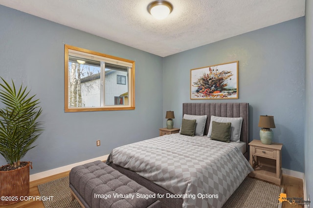 bedroom featuring hardwood / wood-style flooring and a textured ceiling