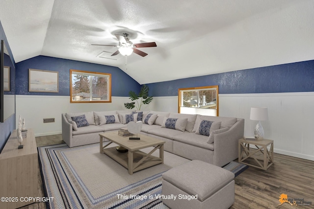 living room featuring lofted ceiling, hardwood / wood-style flooring, a textured ceiling, and ceiling fan