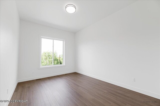 1690 W Valley Ridge Dr, Wasilla, AK 99654 - spare room with dark wood-style floors and baseboards