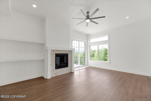 1690 W Valley Ridge Dr, Wasilla, AK 99654 - unfurnished living room featuring a ceiling fan, a glass covered fireplace, wood finished floors, baseboards, and recessed lighting