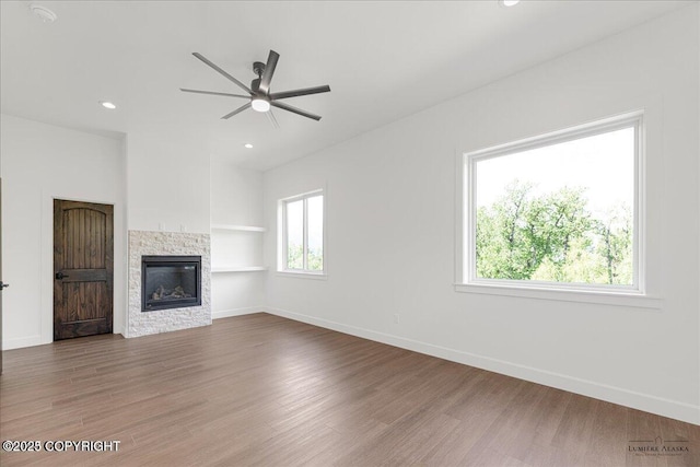 1690 W Valley Ridge Dr, Wasilla, AK 99654 - unfurnished living room featuring a ceiling fan, wood finished floors, a fireplace, baseboards, and recessed lighting