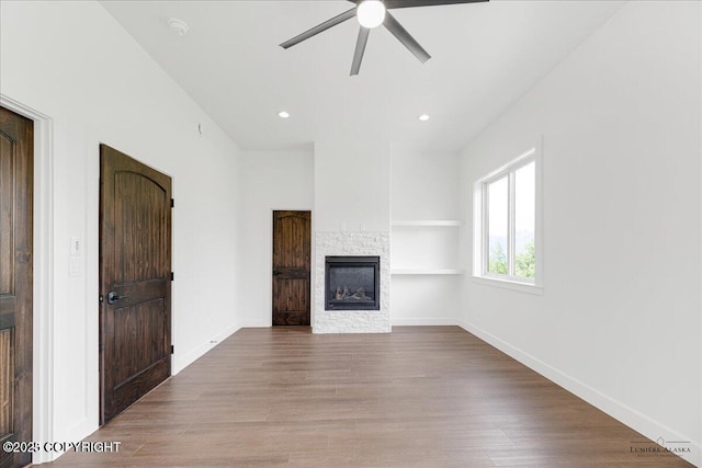 1690 W Valley Ridge Dr, Wasilla, AK 99654 - unfurnished living room with a fireplace, ceiling fan, wood finished floors, baseboards, and recessed lighting