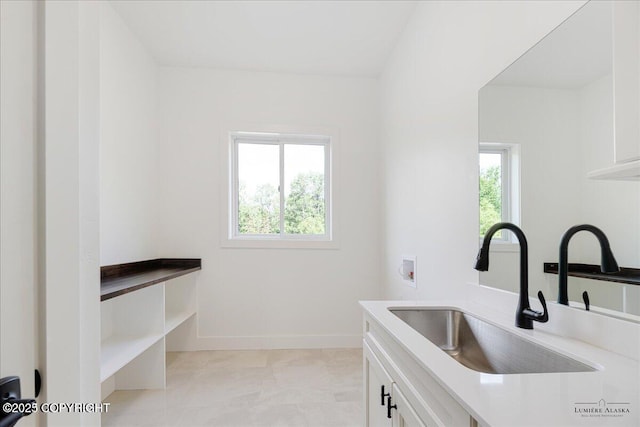 1690 W Valley Ridge Dr, Wasilla, AK 99654 - clothes washing area featuring cabinet space, hookup for a washing machine, and baseboards