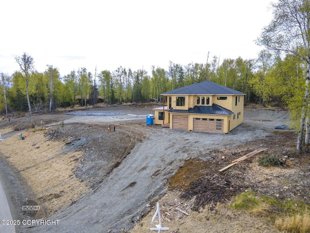 1690 W Valley Ridge Dr, Wasilla, AK 99654 - view of front of property featuring metal roof, view of wooded area, and dirt driveway