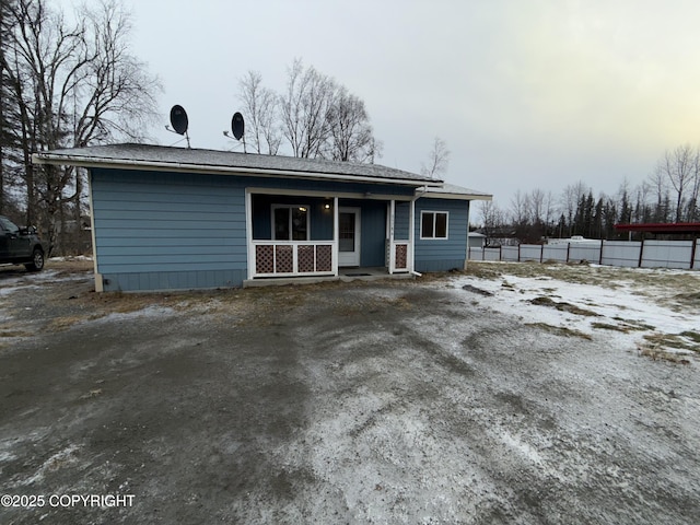 rear view of property featuring a porch