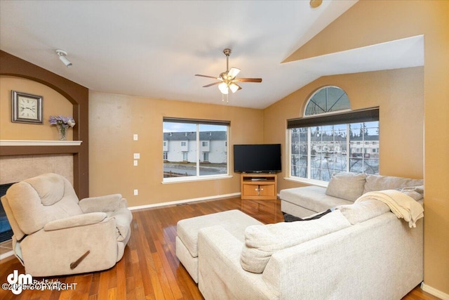 living room with lofted ceiling, wood-type flooring, and ceiling fan