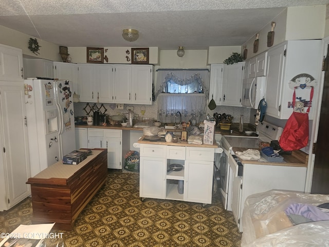 8400 George Ct, Anchorage, AK 99516 - kitchen featuring white cabinets, white appliances, decorative backsplash, and sink