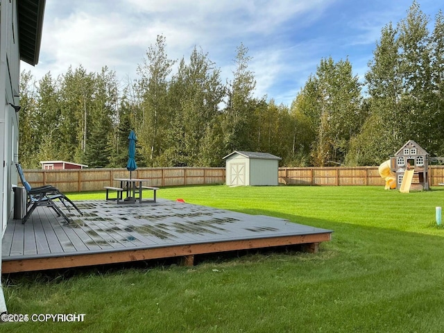 wooden terrace with a playground, a shed, and a lawn