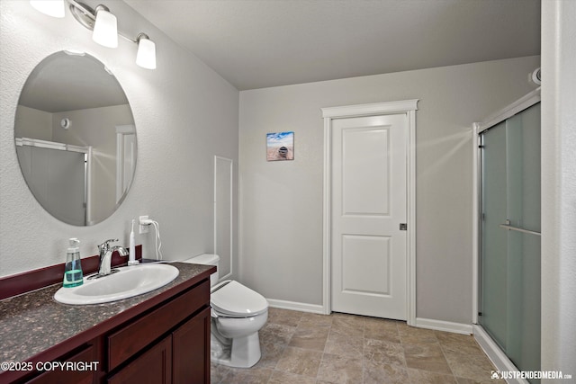 bathroom with vanity, toilet, and walk in shower