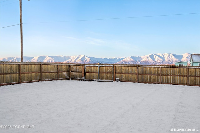 yard covered in snow with a mountain view