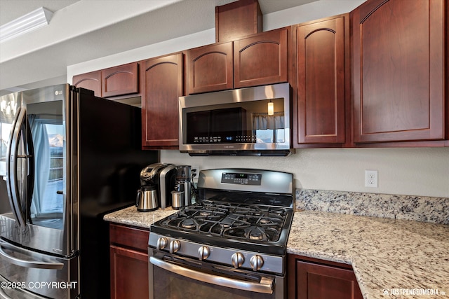 kitchen featuring light stone counters and appliances with stainless steel finishes