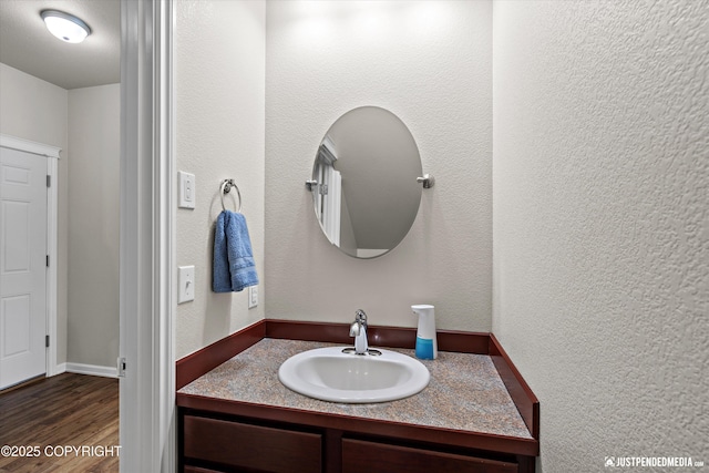 bathroom featuring hardwood / wood-style flooring and vanity