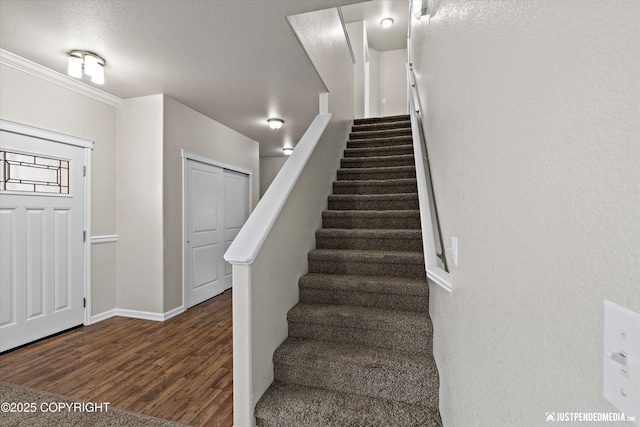 foyer with dark hardwood / wood-style flooring and a textured ceiling