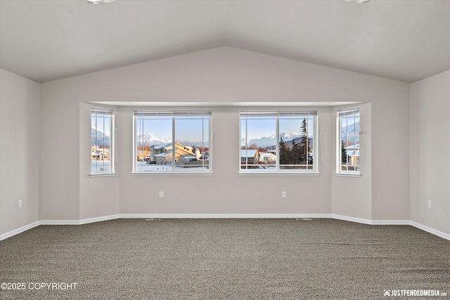 empty room with lofted ceiling and carpet flooring