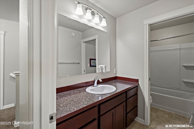 full bathroom with vanity,  shower combination, tile patterned floors, and toilet