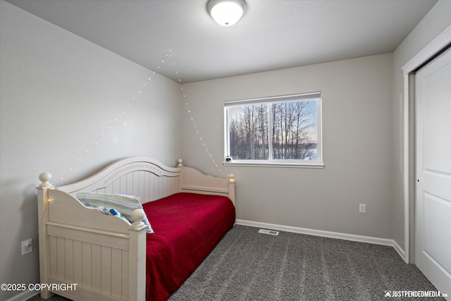 bedroom featuring dark carpet