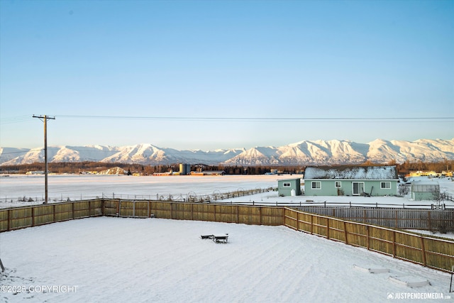 snowy yard with a mountain view