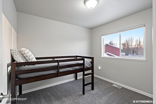 bedroom with dark carpet