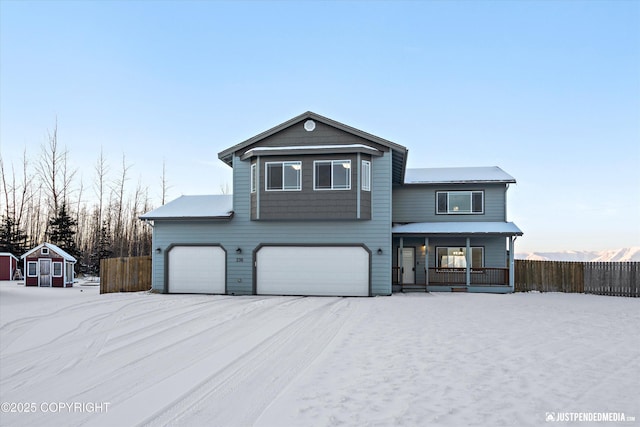 view of property with a garage and covered porch